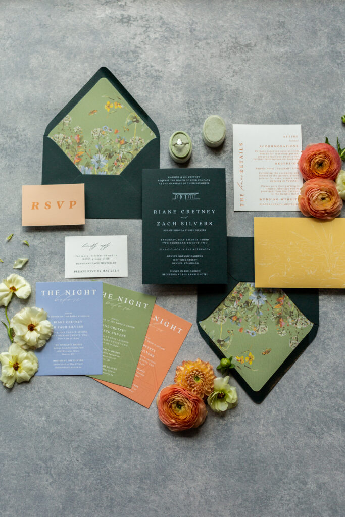 A flat-lay photo of the Denver wedding invitation stationary 