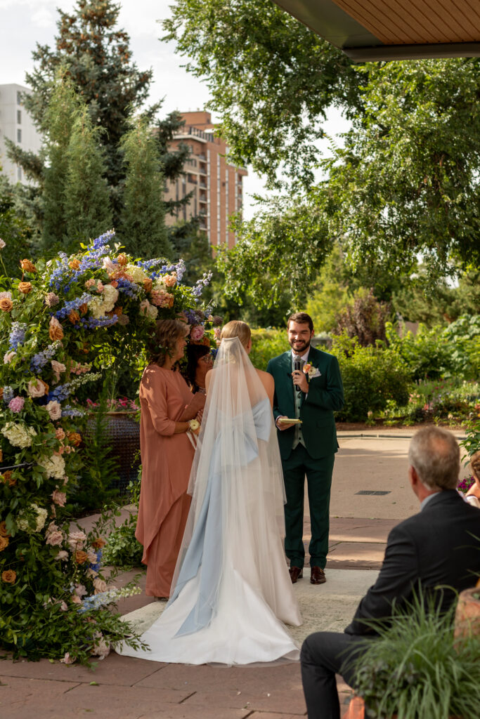 Groom reads vows to his future wife at the alter in the Denver Botanic Gardens