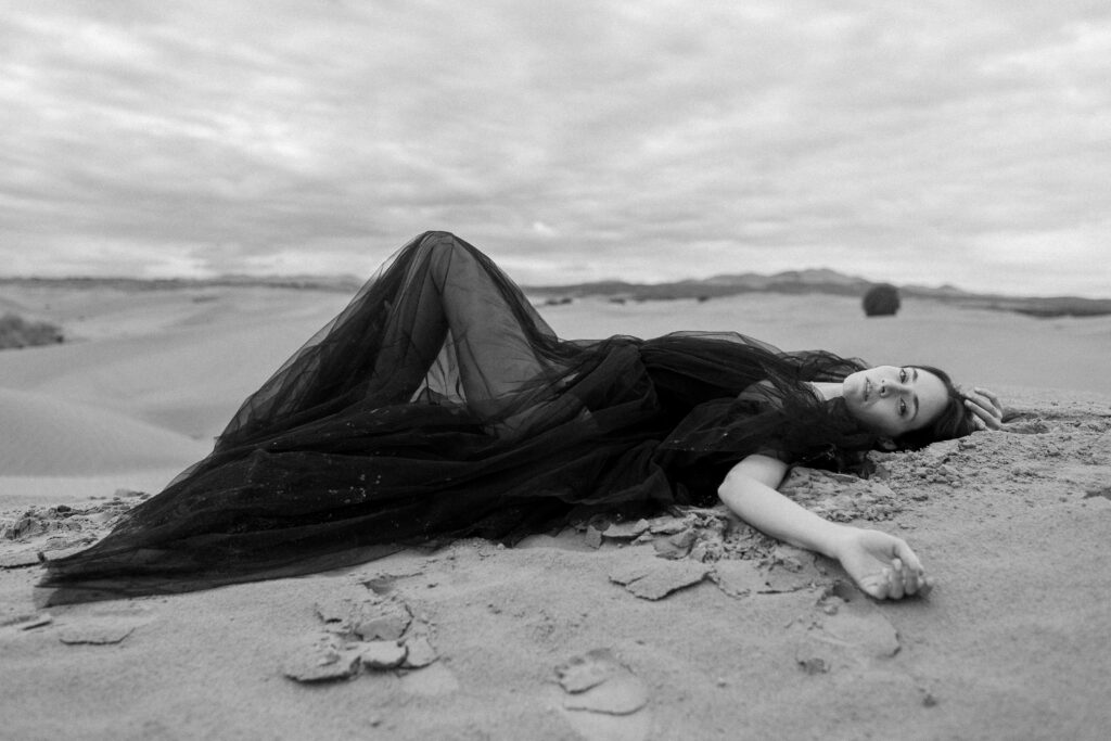 model in the sand for an editorial photoshoot in utah
