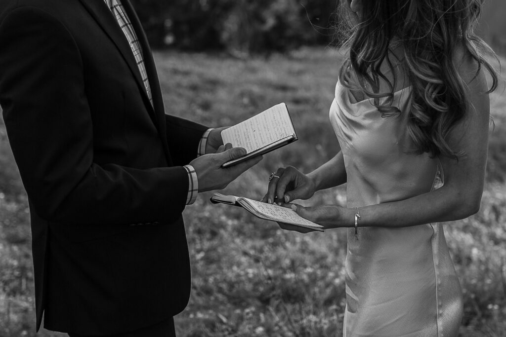 bride and groom reading their vows to each other