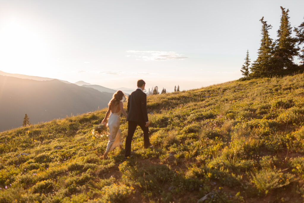 aspen elopement with bride and groom walking away after just married photos