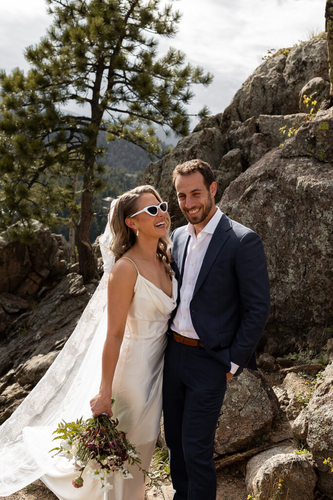 bride and groom smile before wedding at flagstaff house in boulder colorado