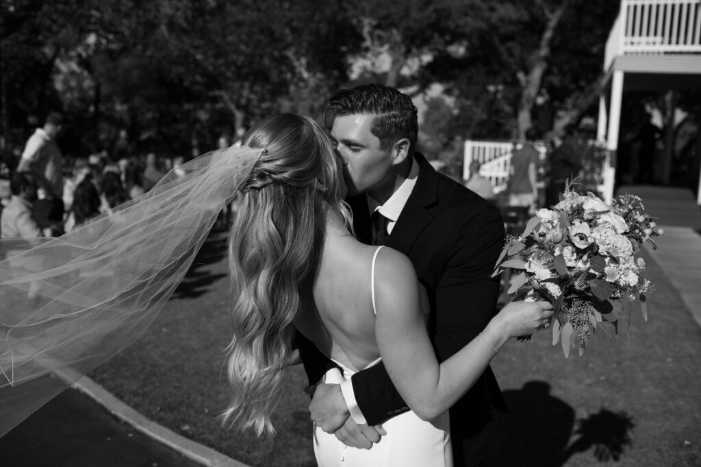 Bride and groom kissing after wedding in California