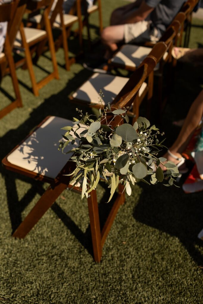 Small wedding ceremony in California with rustic wooden chairs