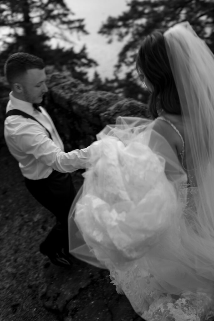 groom helps bride at adventure wedding in oregon