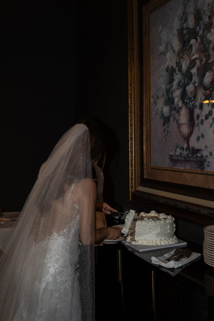 bride and groom cut the cake at their oregon romantic wedding