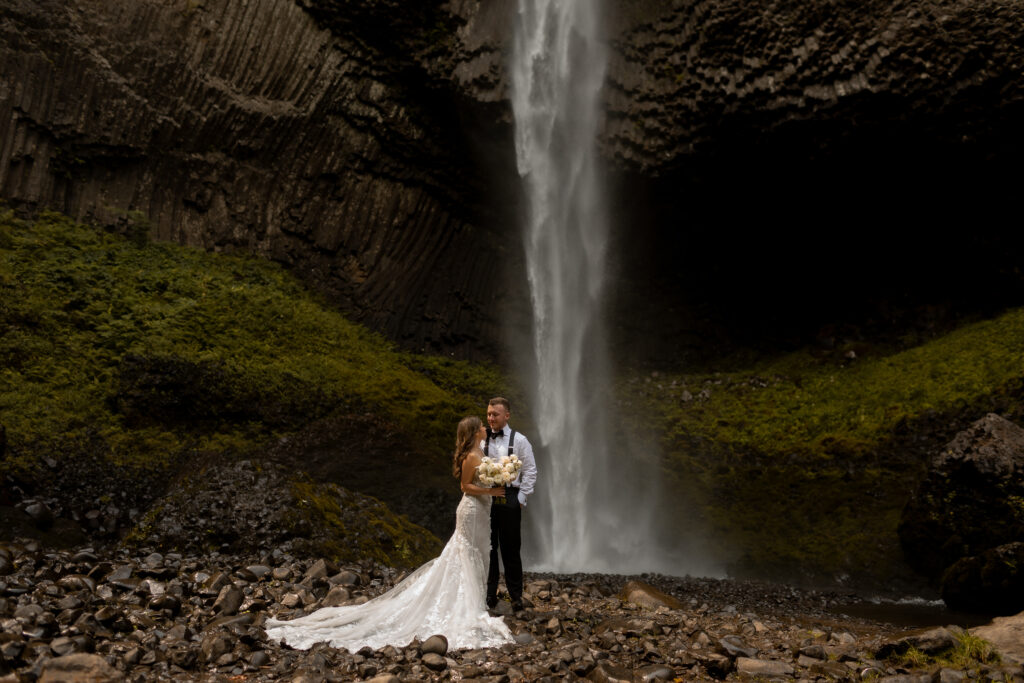 oregon wedding photographer documents waterfall and bride and groom