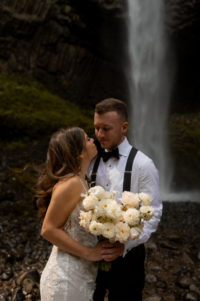 bride and groom at waterfall for wedding photos in oregon