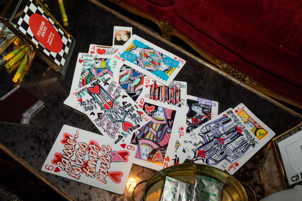 The artwork of the bride, showcased for her guests as party favors. Full of vibrant colorful playing cards.