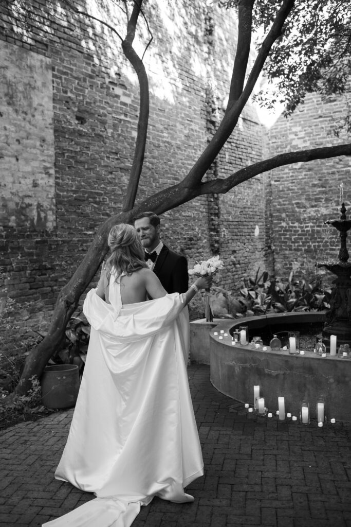 The first look with the bride and groom. The groom tries to hold back tears however they break through, the bride walks up to him with arms open wide looking for a hug.