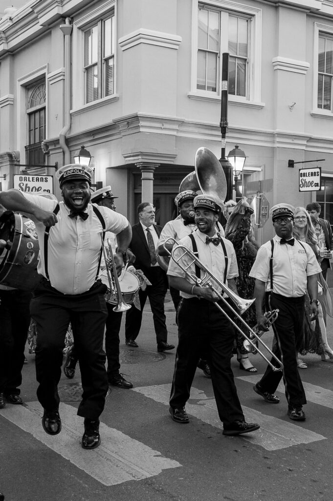 Second line playing drums and the trumpet dancing in the infamous Bourbon Street of New Orleans.