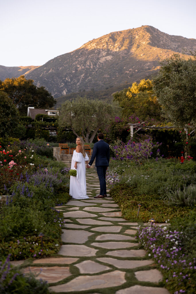 couple walks through the gardens at san ysidro ranch for their wedding