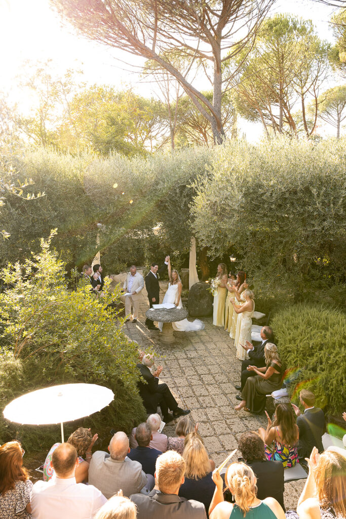 bride and groom celebrate at their ceremony after their first kiss