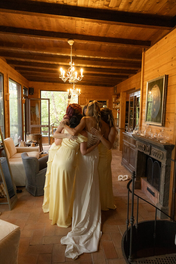 bride and bridesmaids hugging in the getting ready house at le 7 fonti in rome