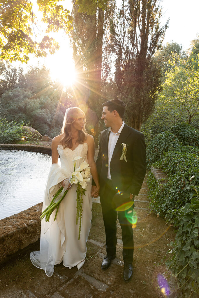 bride and groom looking at each other holding hands after their wedding ceremony
