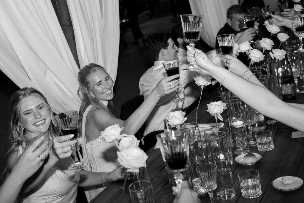 bride cheers her guests during wedding speeches