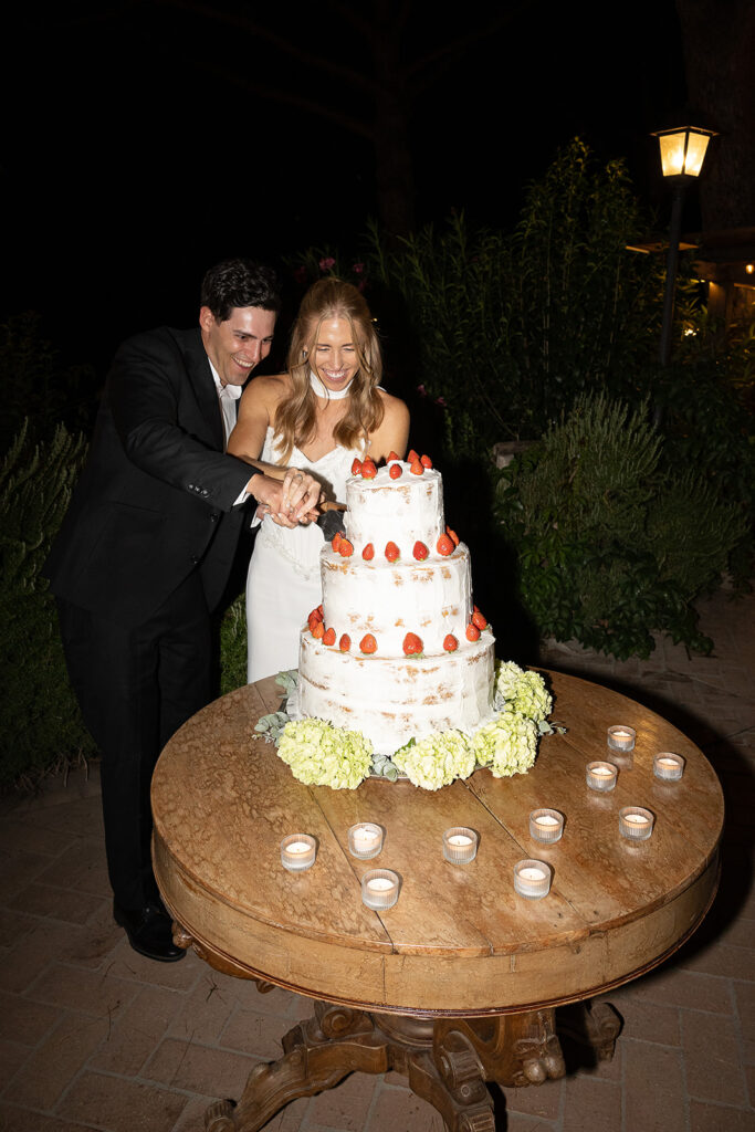 bride and groom cutting the cake at their wedding reception