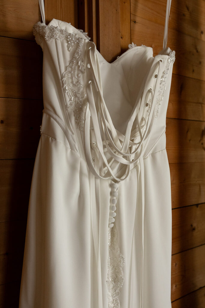 back of a beautiful wedding dress hanging at rome wedding venue