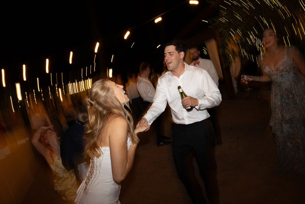 bride and groom singing and dancing at their le 7 fonti wedding reception