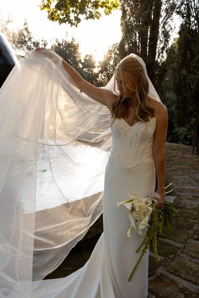 bride showing her veil in the sun