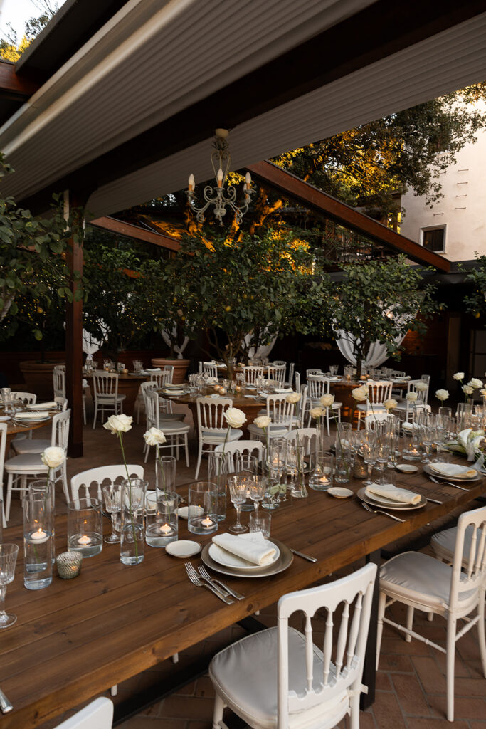beautiful white roses and table settings at weddign in italy